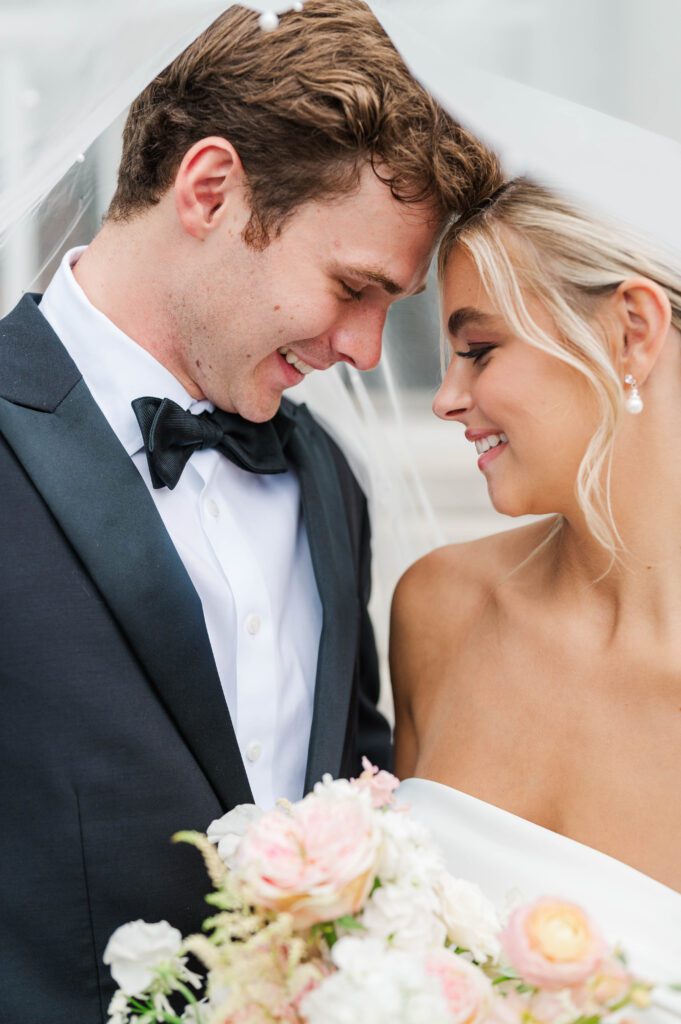 Bride and groom pose in front of Laurel Court on their wedding day in Cincinnati