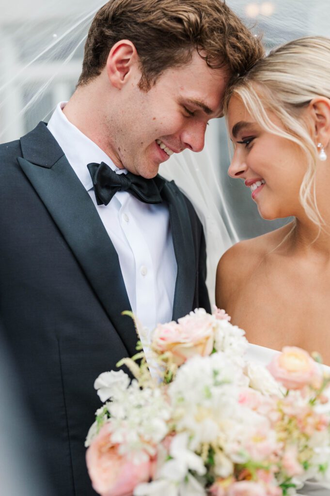 Bride and groom pose in front of Laurel Court on their wedding day in Cincinnati
