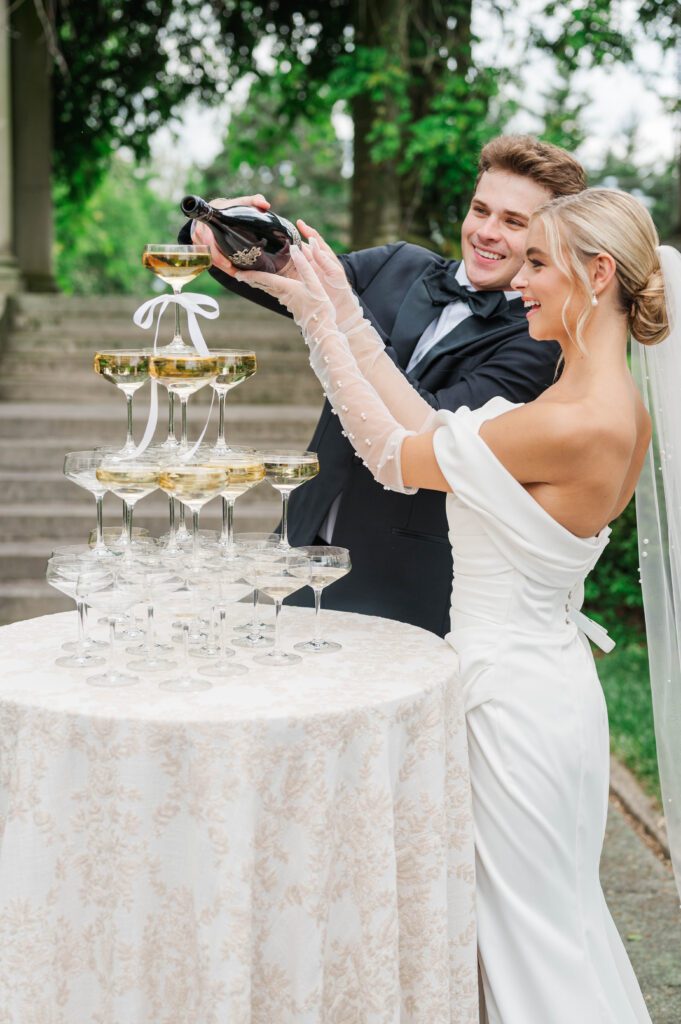 Bride and groom pour their champagne on their wedding day at Laurel Court in Cincinnati