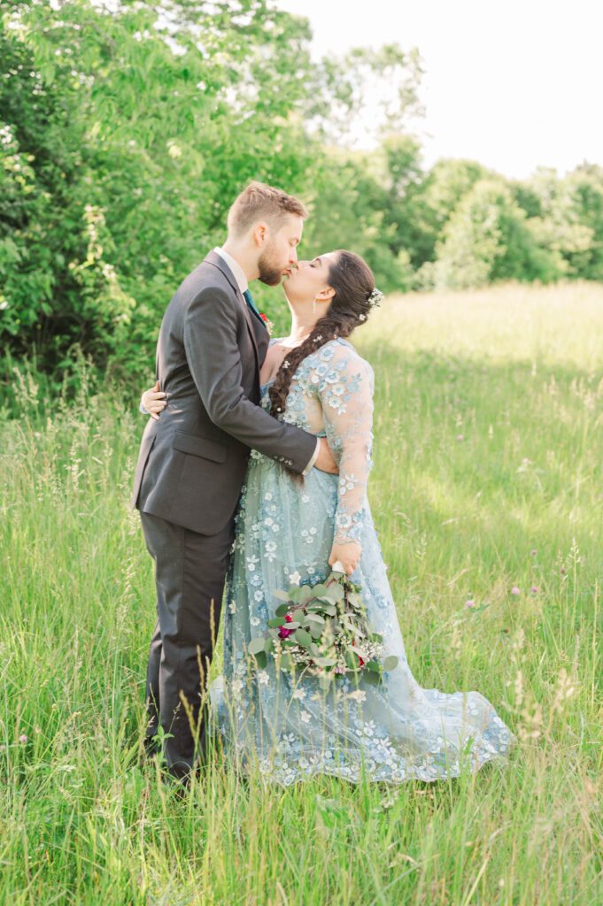 Bride and groom share a kiss after their wedding ceremony. 