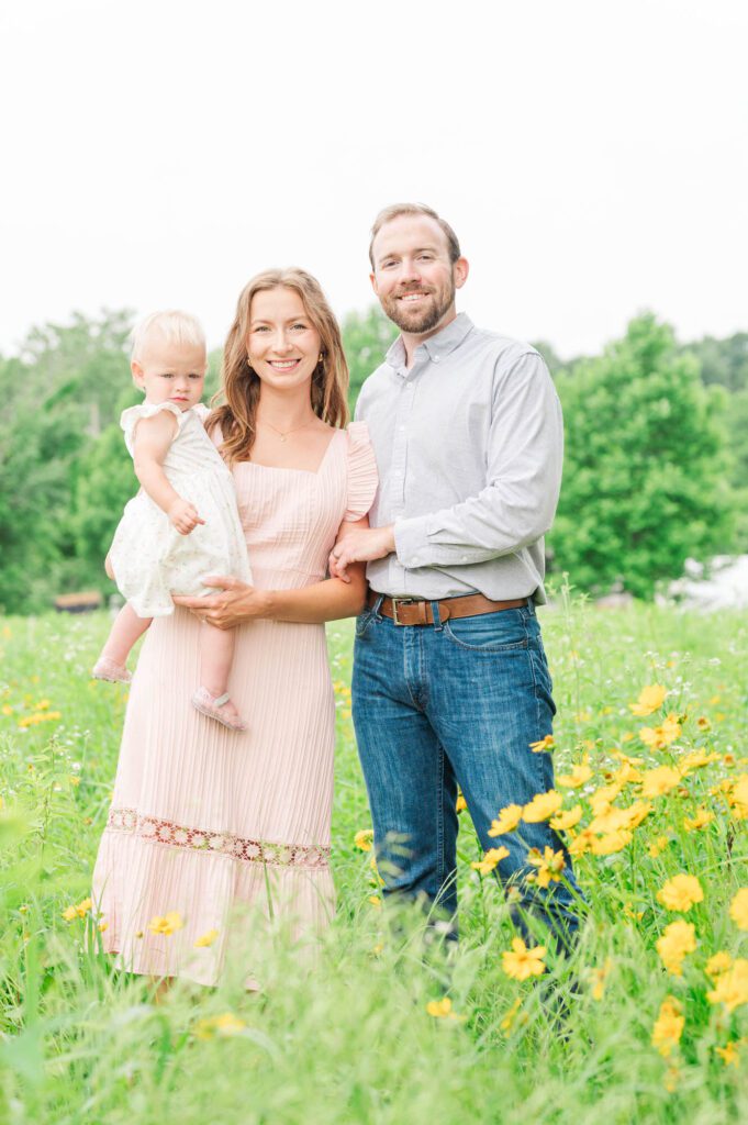 Mom, dad, and baby smile at the camera during their Louisville photo session