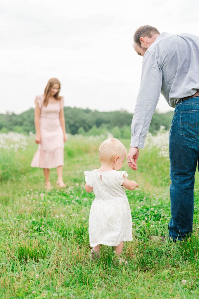 A candid shot of mom, dad, and baby during their family session