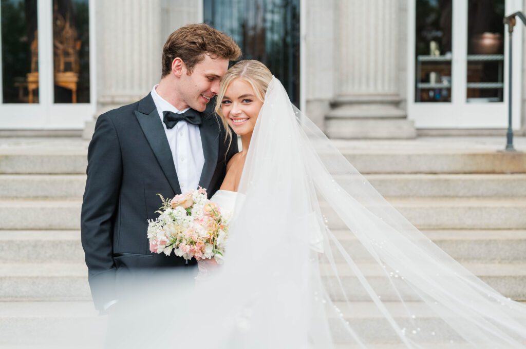 Bride and groom pose in front of Laurel Court on their wedding day in Cincinnati