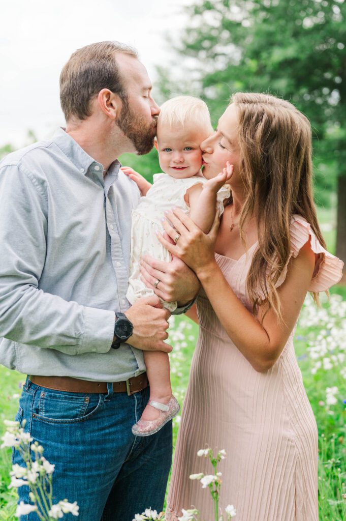 Mom and dad give their baby a kiss during their Louisville photo session
