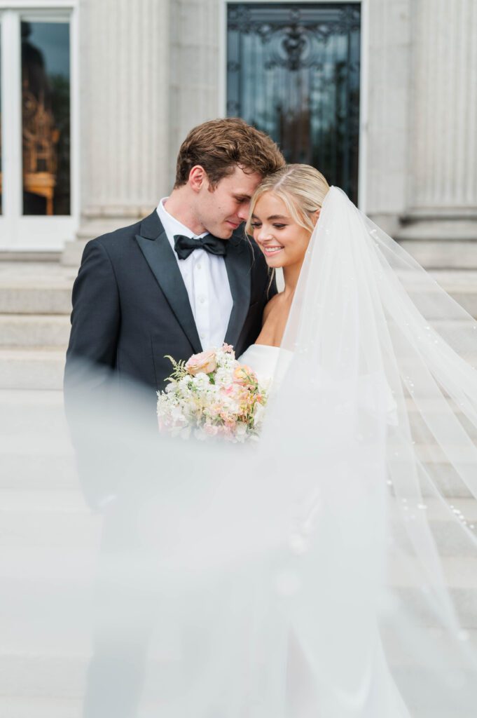 Bride and groom pose in front of Laurel Court on their wedding day in Cincinnati