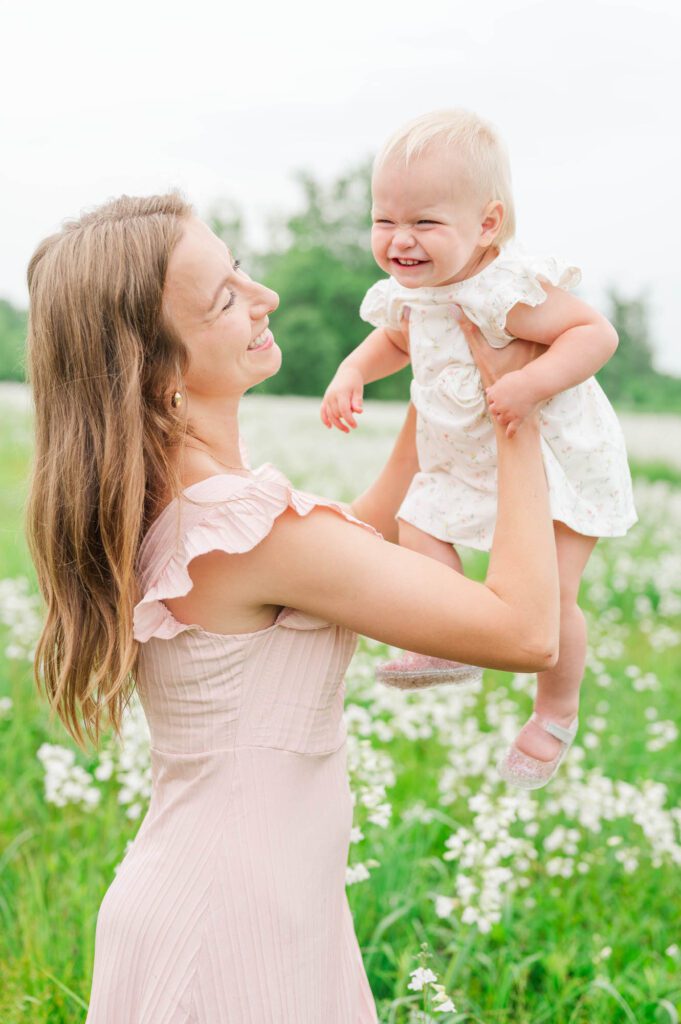 Mom lifts baby in the air during their Louisville family session