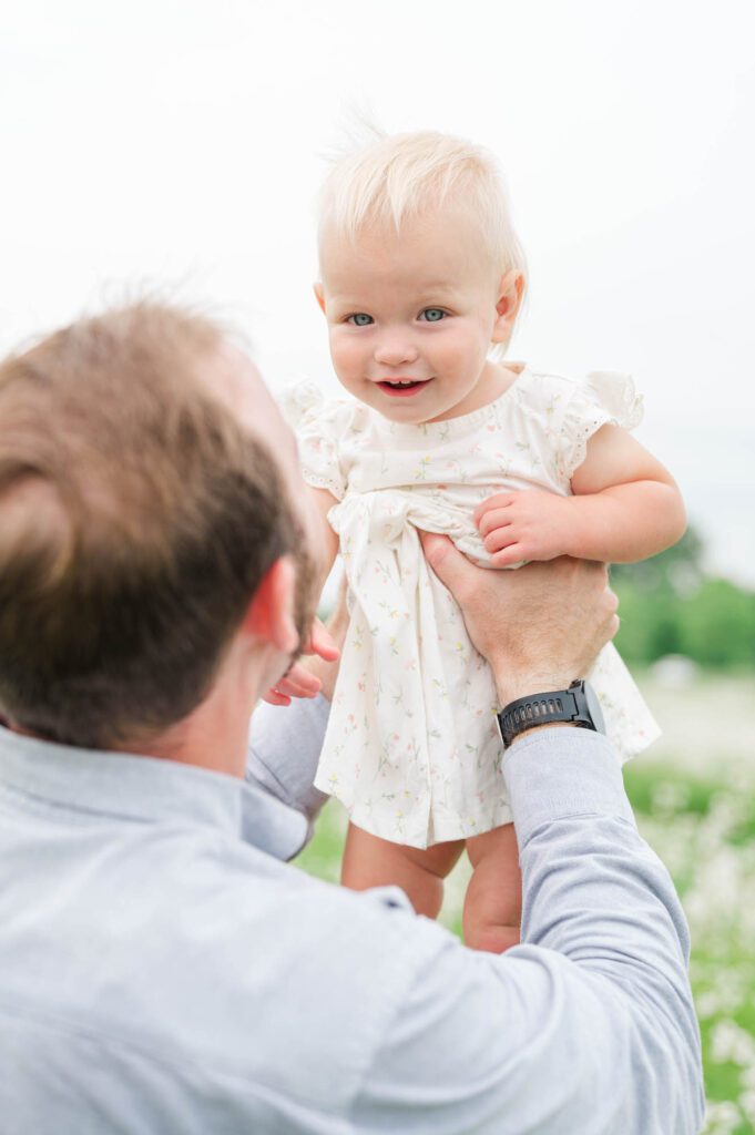 Dad lifts his daughter in the air during their Louisville family session