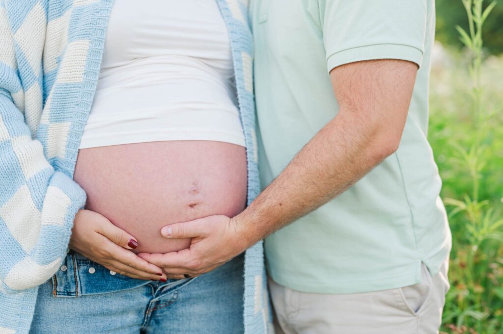 A close up of couple's hands on baby bump for their maternity session