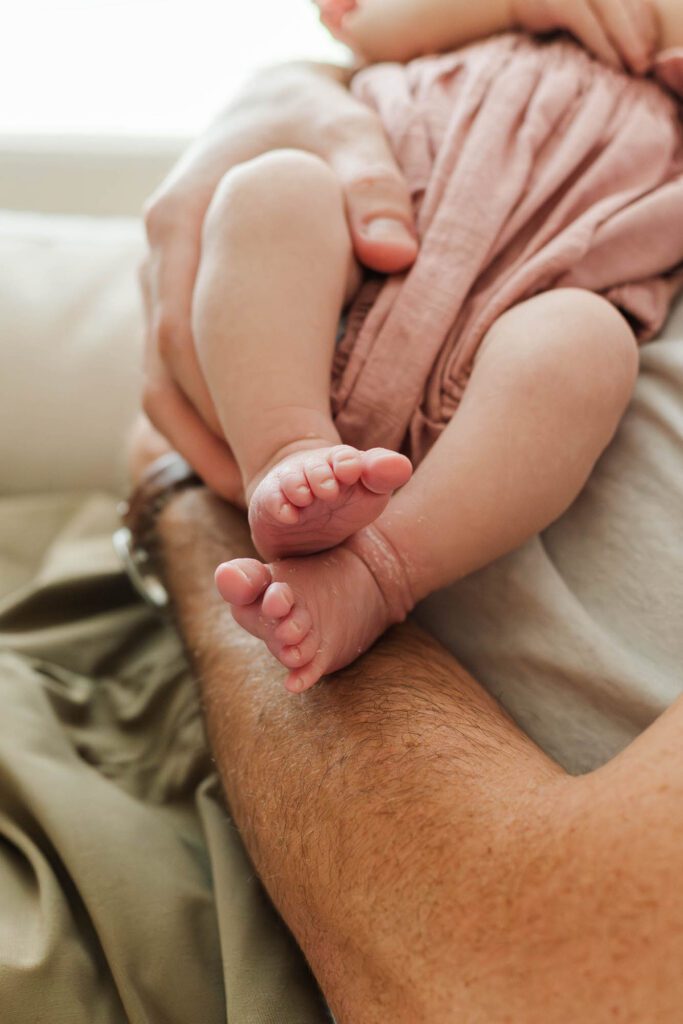 New dad holds his baby girl in the nursery