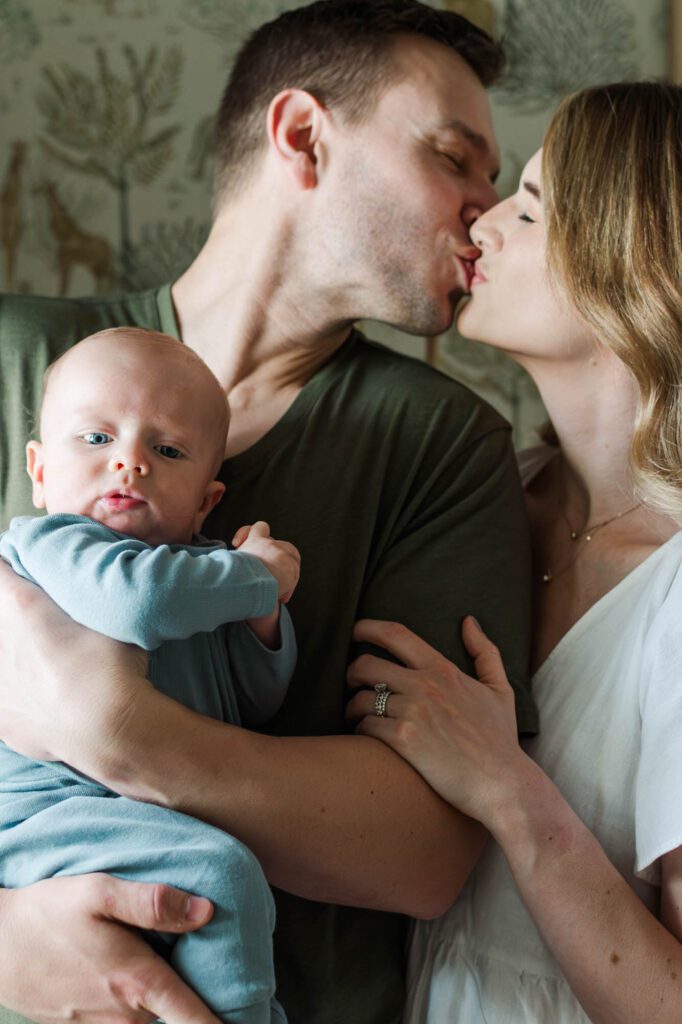 Family stands together in the nursery with their 3 month old for their Louisville in-home family session