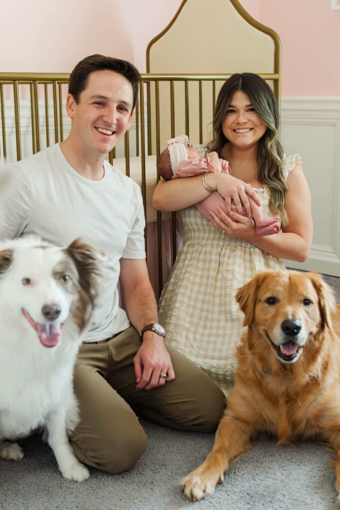 New mom and dad hold their baby girl in the nursery for their Louisville, KY in-home newborn session