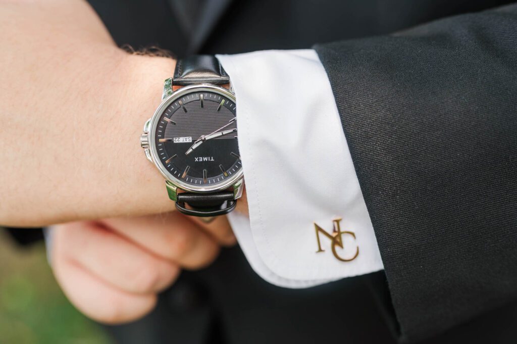 Close up shot of the groom's watch and cuff links