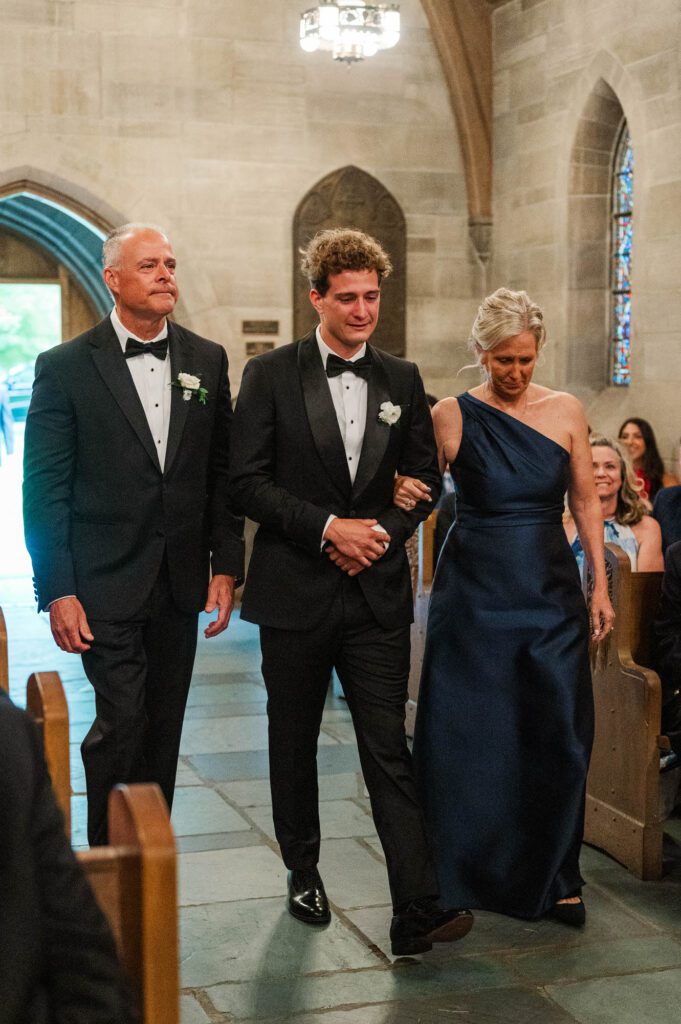 Louisville Wedding Photographer-18 Groom walks down the aisle with his mom and dad before the wedding ceremony