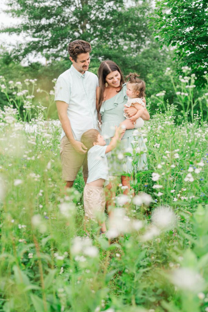 Family poses in wildflowers at Beckley Creek Park in Louisville for their photography session