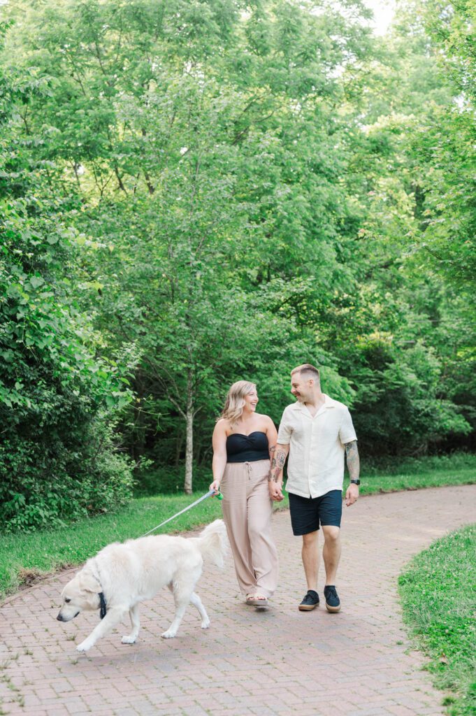 Couple walks their dog at Anchorage Trail in Louisville
