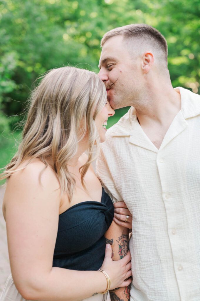 Couple gives forehead kiss during their photo session