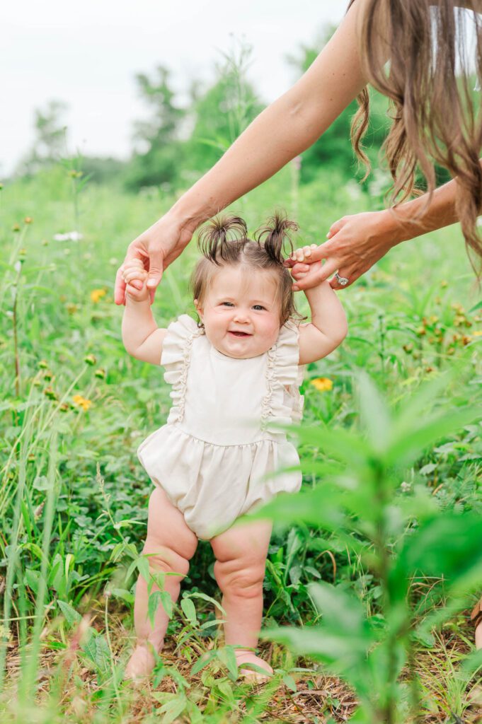 Mom holds 8 month old daughter for their family session in Louisville, KY