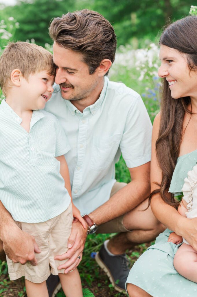 Family poses in wildflowers at Beckley Creek Park in Louisville for their photography session