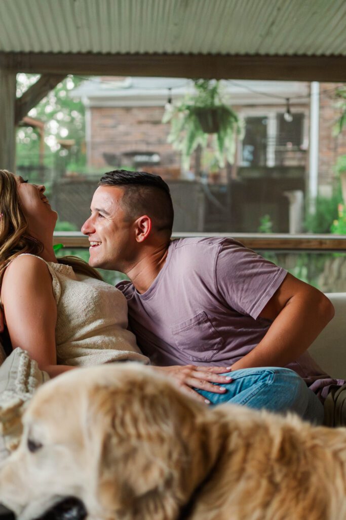 Couple sits together on their couch for their in-home couples session in Louisville, KY