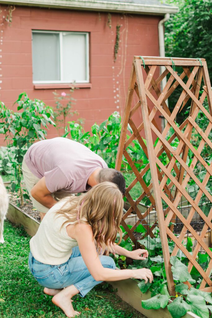 Couple stands in the backyard of their home laughing during their in-home session in Louisville, KY