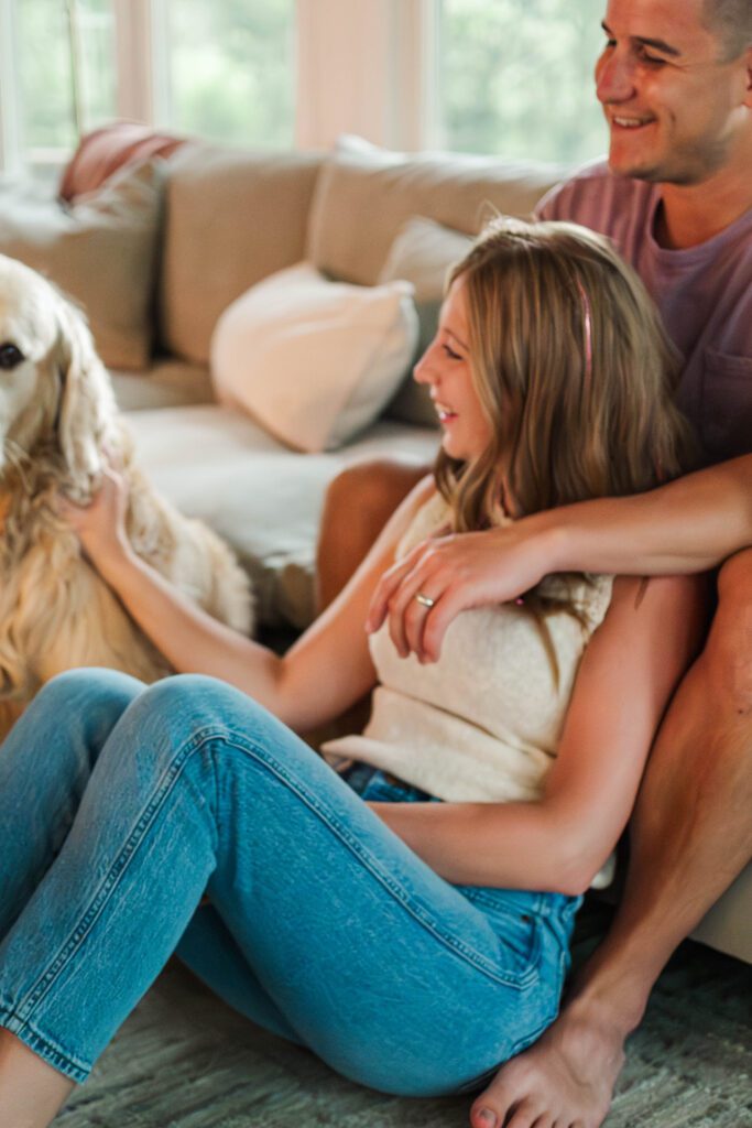 Couple sits together on their couch for their in-home couples session in Louisville, KY