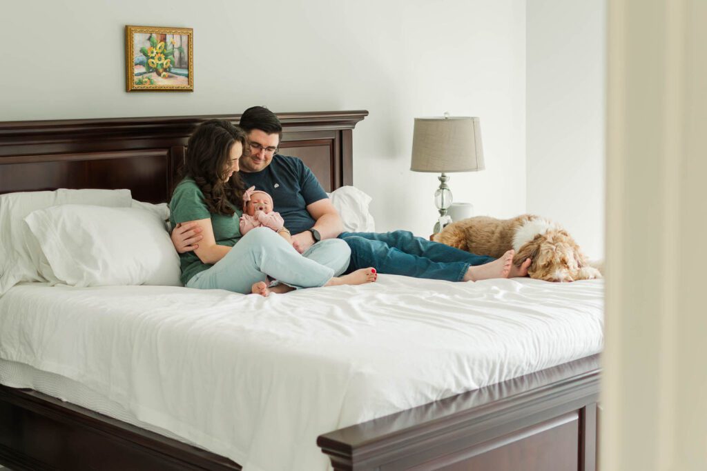 New parents hold their baby girl for their Louisville newborn photography session