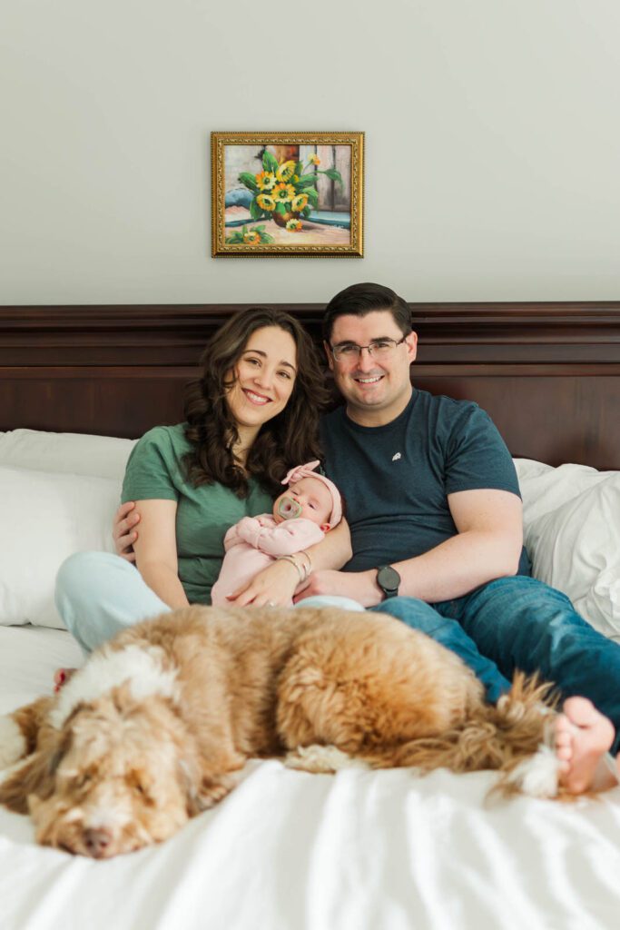 New parents hold their baby girl for their Louisville newborn photography session