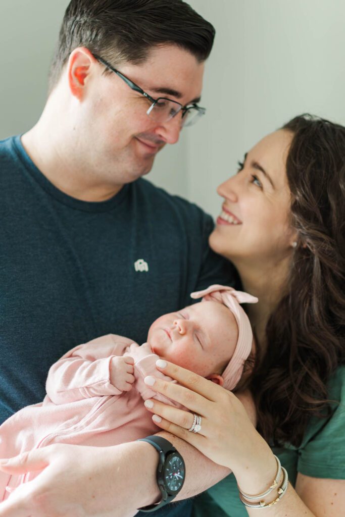 New parents hold their baby girl for their Louisville newborn photography session