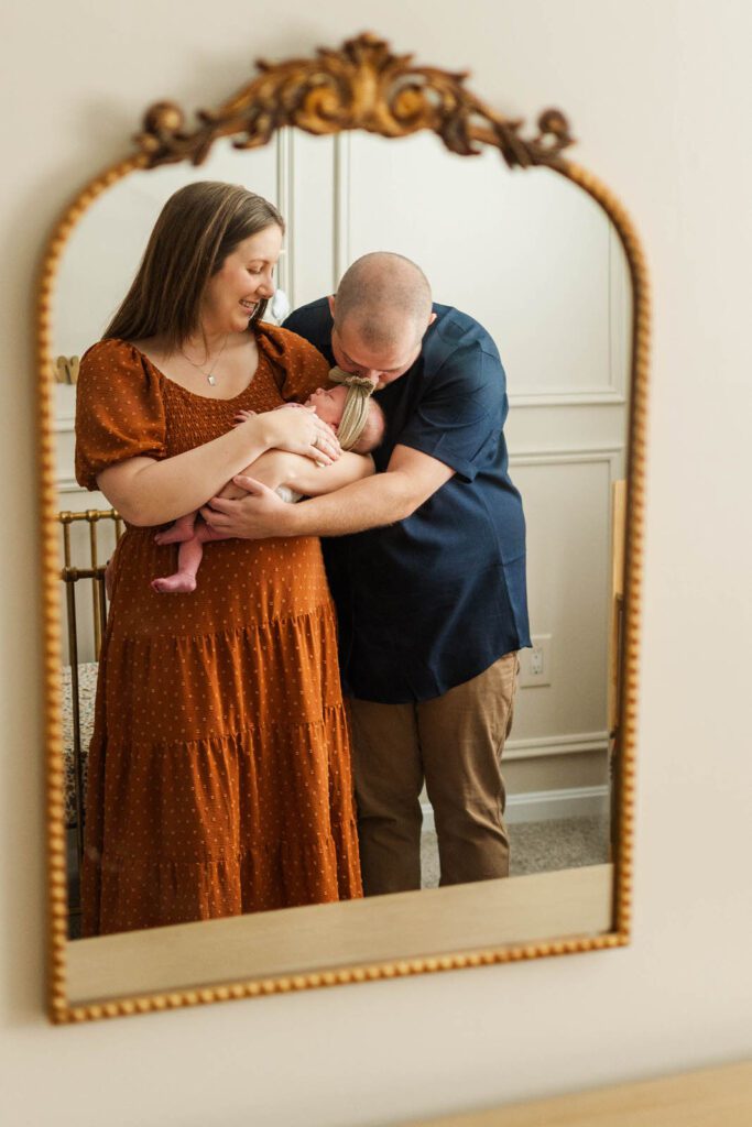 New parents hold newborn during their in-home photography session in Louisville, KY