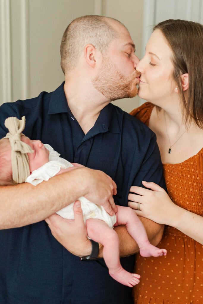 New parents hold newborn during their in-home photography session in Louisville, KY