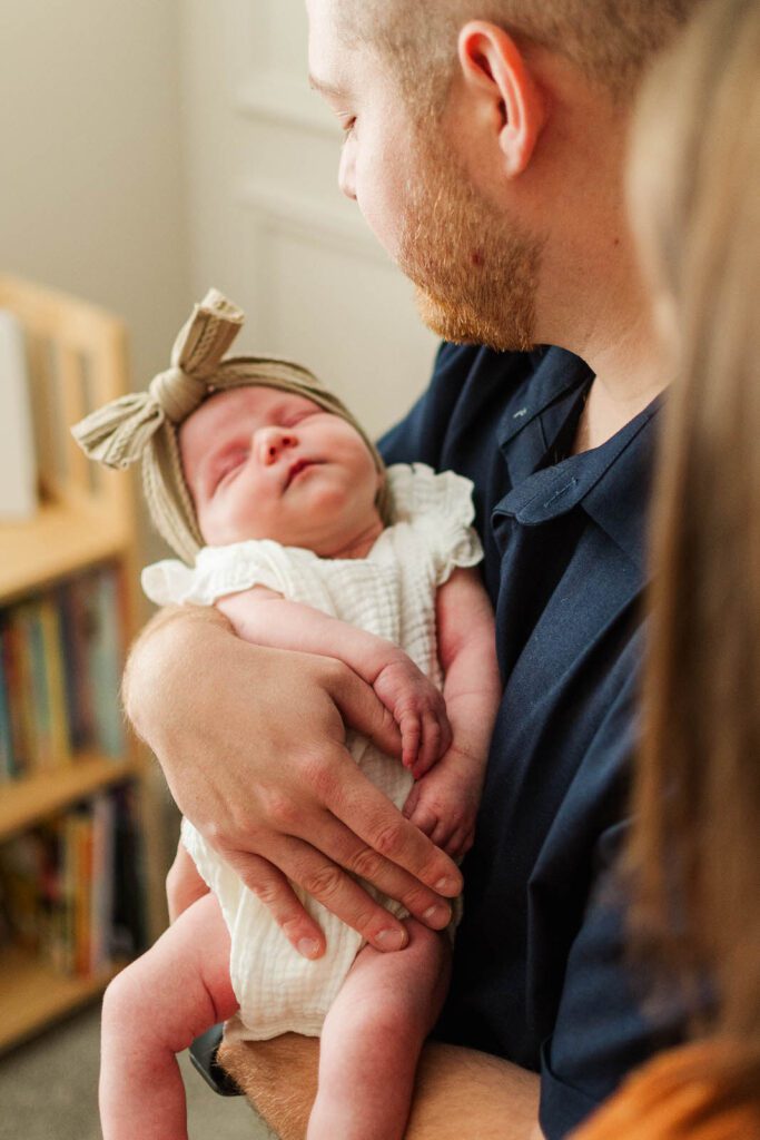 New parents hold newborn during their in-home photography session in Louisville, KY
