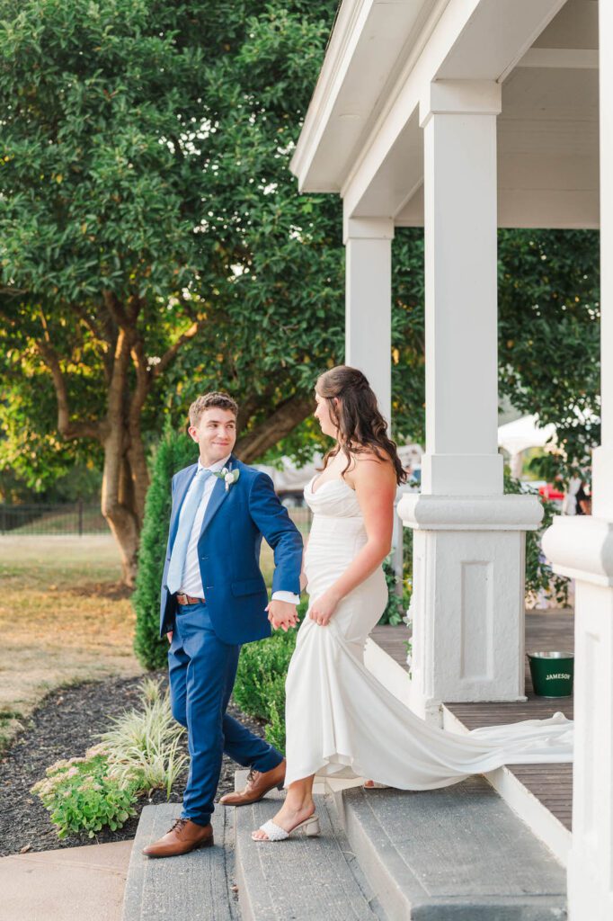 Couple walks down the steps at Presley House on their wedding day.