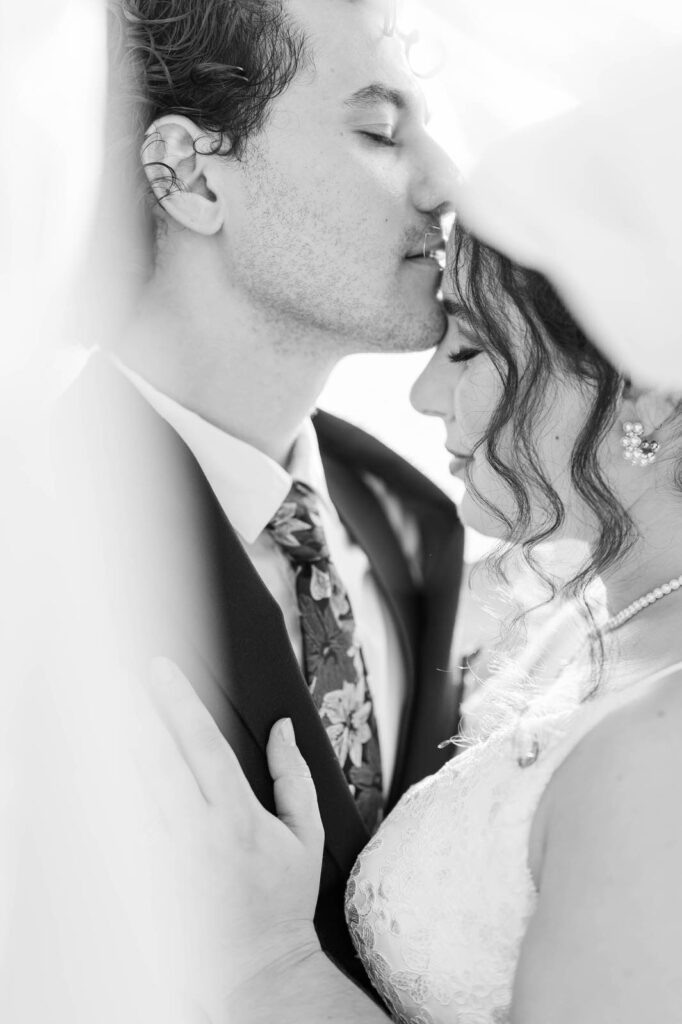 Couple embraces on wedding day at Richwood on the River