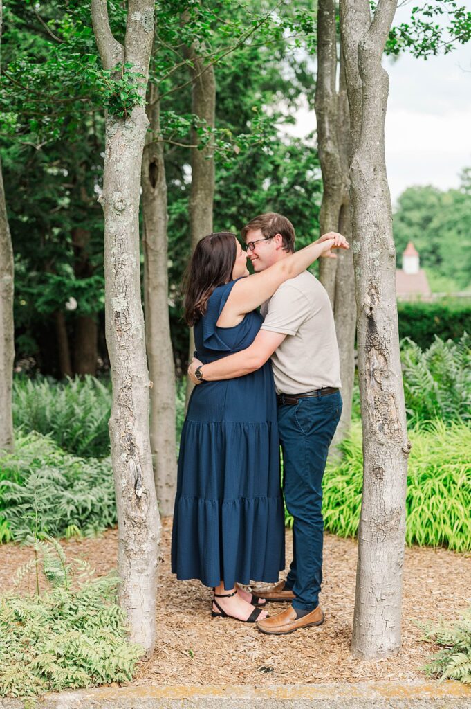 Engaged couple smiles at each other at Yew Dell Botanical Gardens