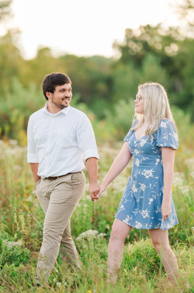 Couple walks hand in hand in Beckley Creek Park for their Louisville engagement session