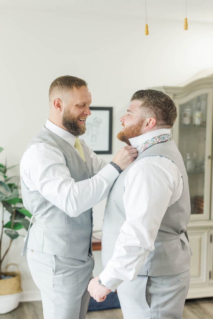 Best man helping the groom get ready on his wedding day