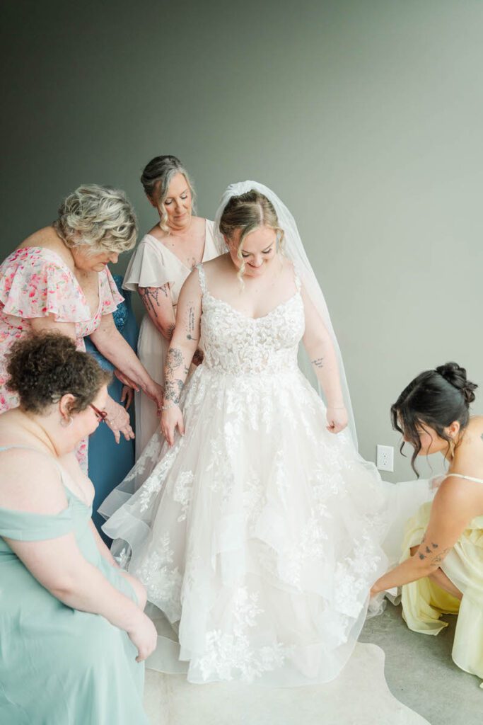 Bride gets into her wedding dress at The Ice House in Louisville, KY