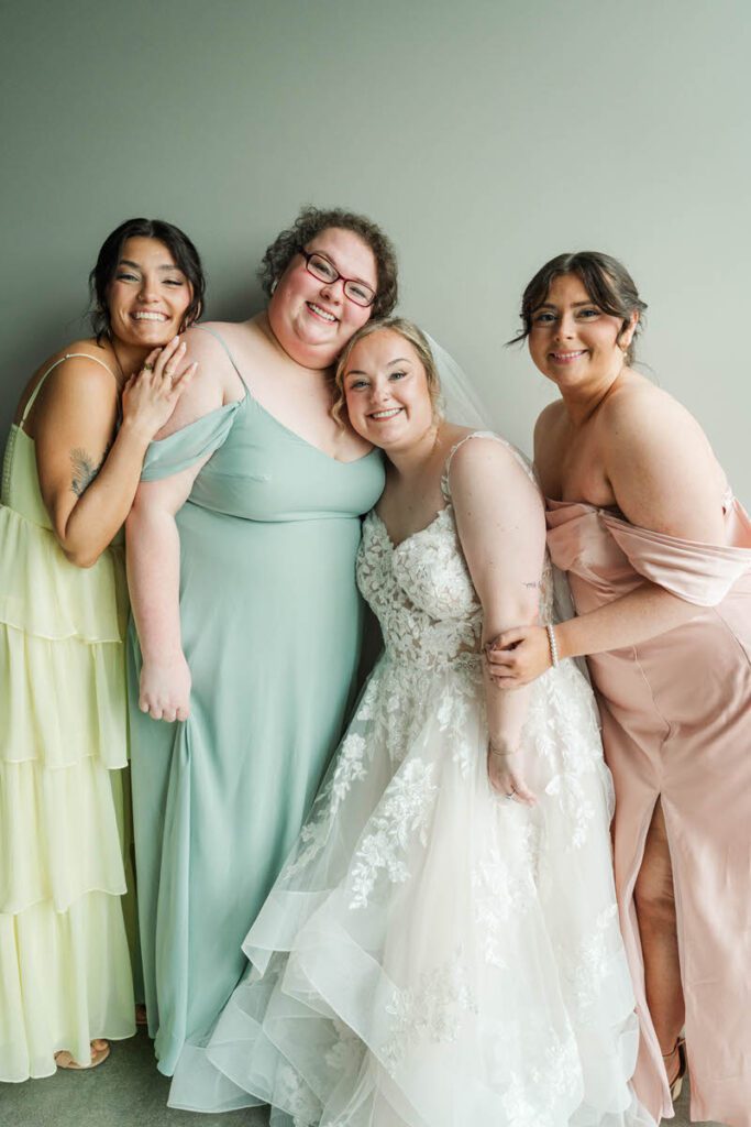 Bride with bridesmaids on wedding day at The Ice House in Louisville, KY