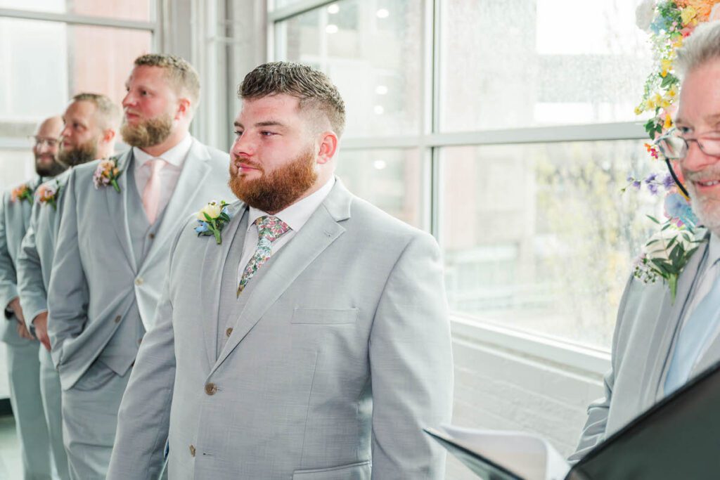 Groom watches the bride walk down the aisle at The Ice House in Louisville