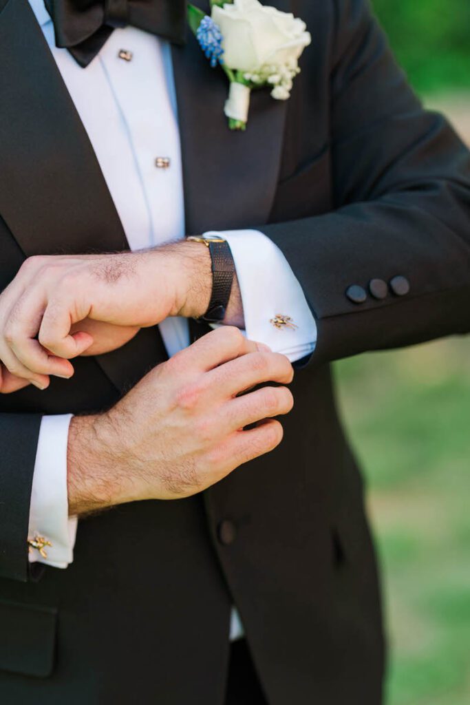 Groom putting on his cufflinks for his wedding day