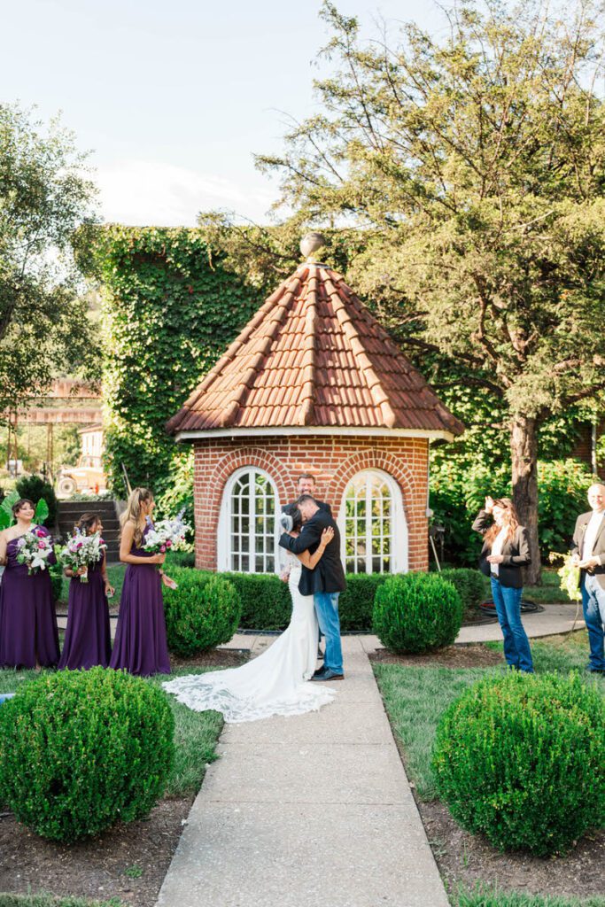 Bride and groom's first kiss during their wedding ceremony at Castle and Key