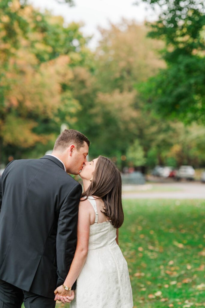 Couple kisses in front of the fountain at Saint James Court for their engagement session.