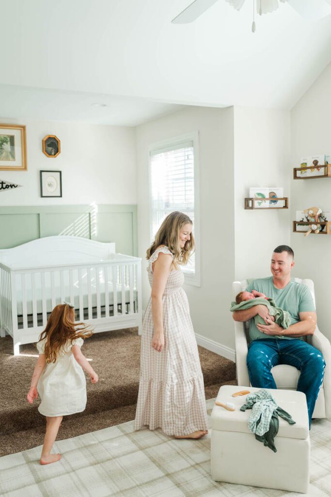 A family plays together in the nursery.

Louisville In-Home Newborn Photographer

Michelle Bordenkircher Photography