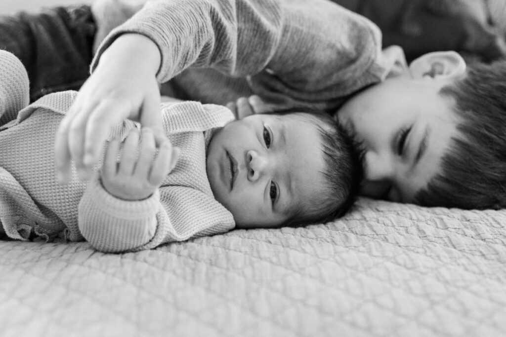 Big brother lays with newborn during a Louisville in home newborn session.
Photos by Michelle Bordenkircher Photography