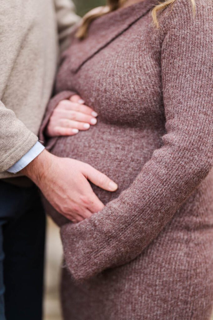 A mom and dad to be place their hands on mom's belly during a winter maternity session at Anchorage Trail.
Michelle Bordenkircher Photography