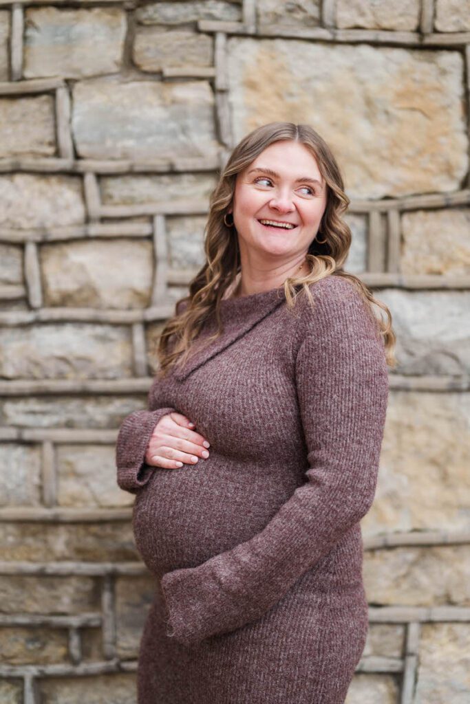 A mom-to-be smiles as she poses for her winter maternity session at Anchorage Trail.
Michelle Bordenkircher Photography