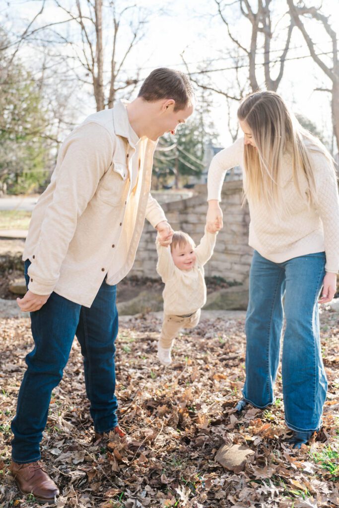 A mom and dad play with their toddler during their family session at Anchorage Trail in Louisville, KY

Photos by Michelle Bordenkircher Photography