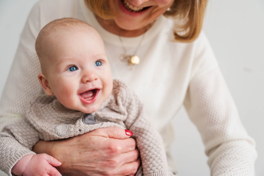 A grandmother smiles while holding her grandson. 

Louisville Motherhood Photographer 

Photos by Michelle Bordenkircher Photography