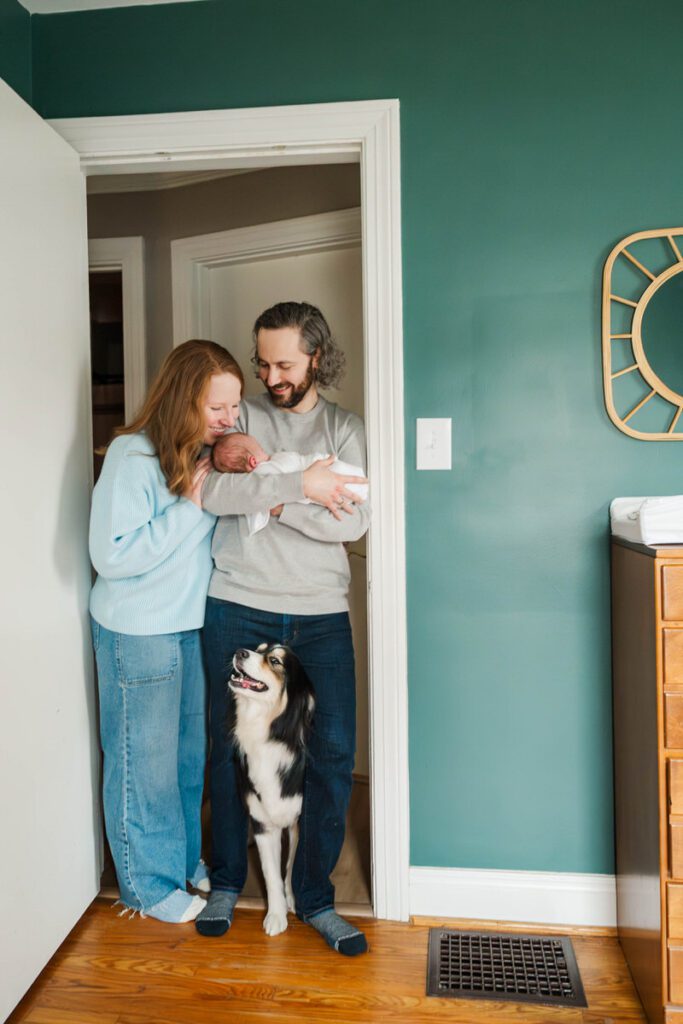 A new mom and dad smile while posing with their newborn baby.
Louisville In Home Newborn Session
Photos by Michelle Bordenkircher Photography