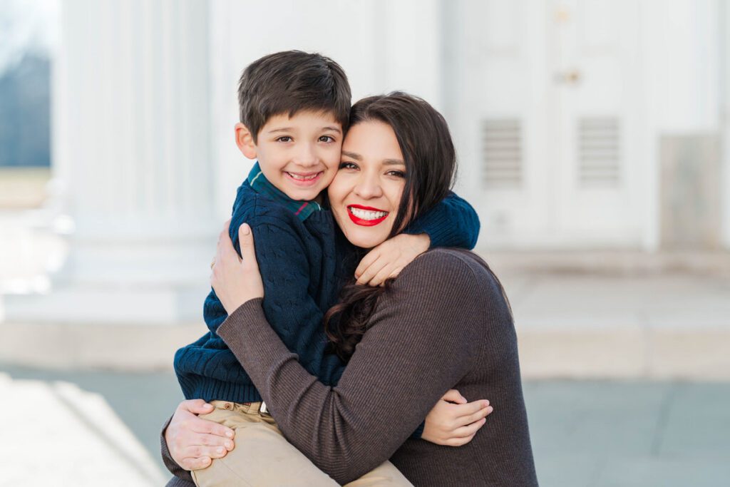 A boy hugs his mom during a winter family session. Photos by Michelle Bordenkircher Photography
